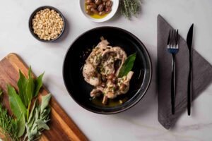 Coniglio olive, pinoli e alloro