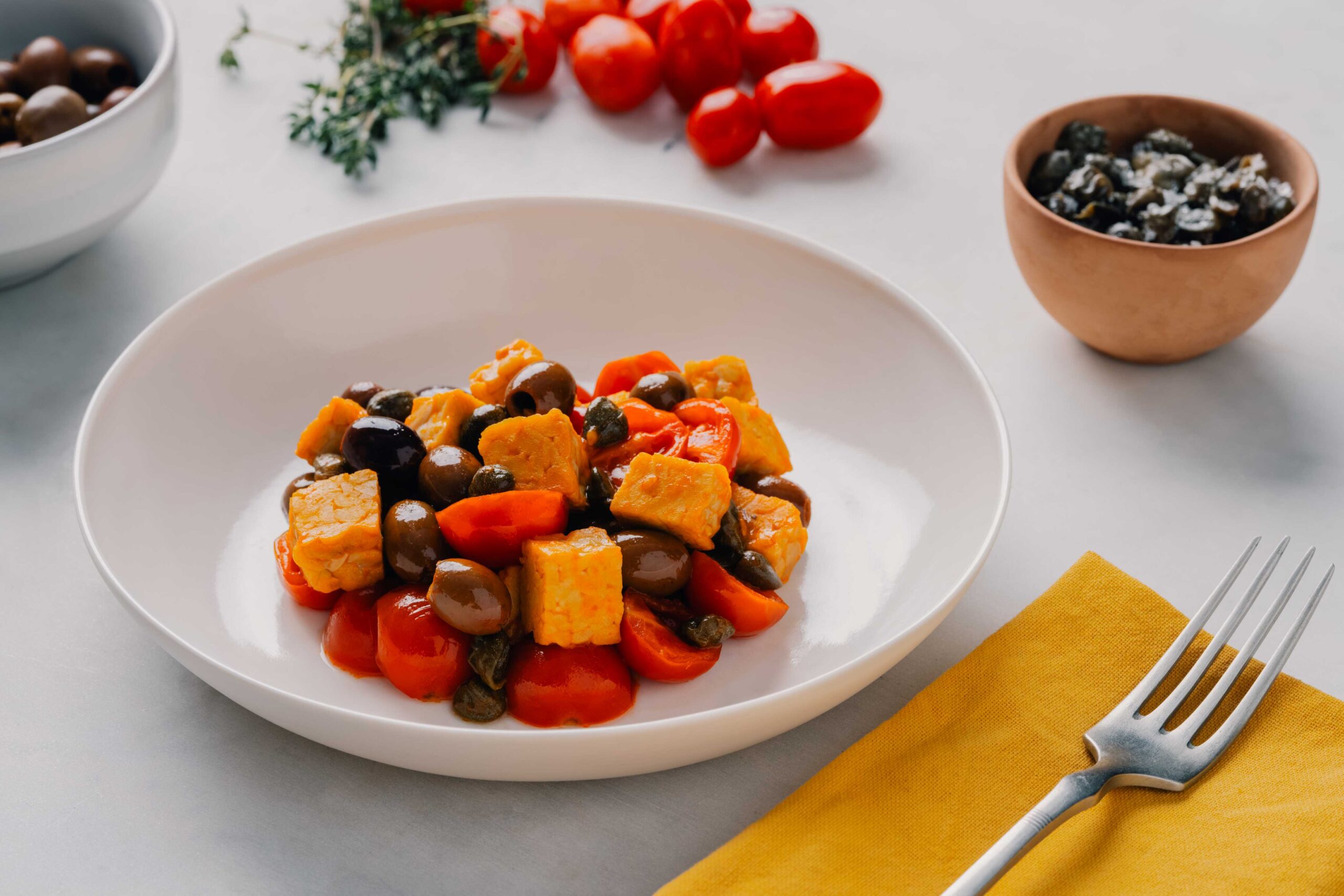 Temphé with cherry tomatoes, olives and capers