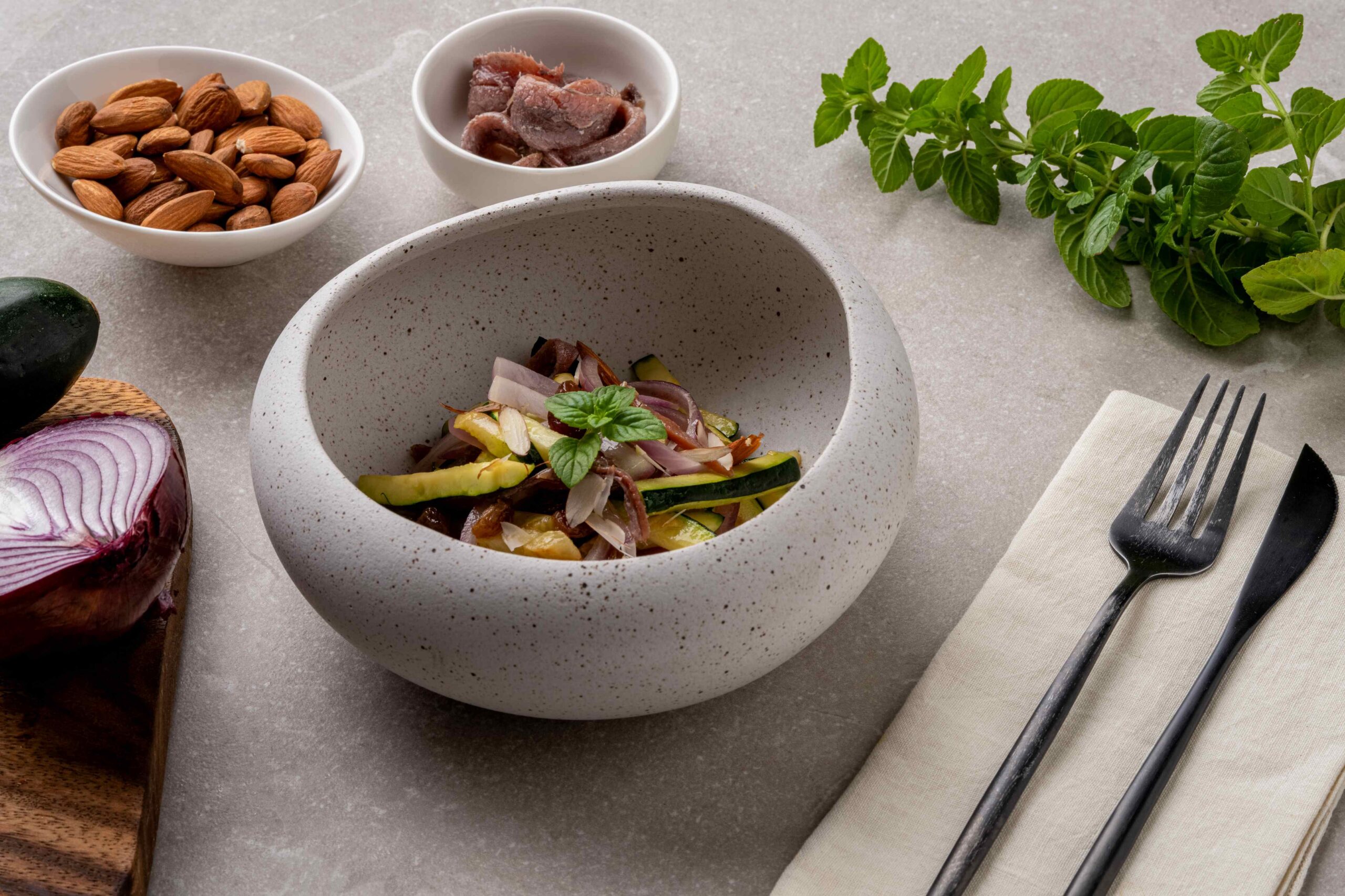 Sweet and sour courgettes with raisins, almonds and honey