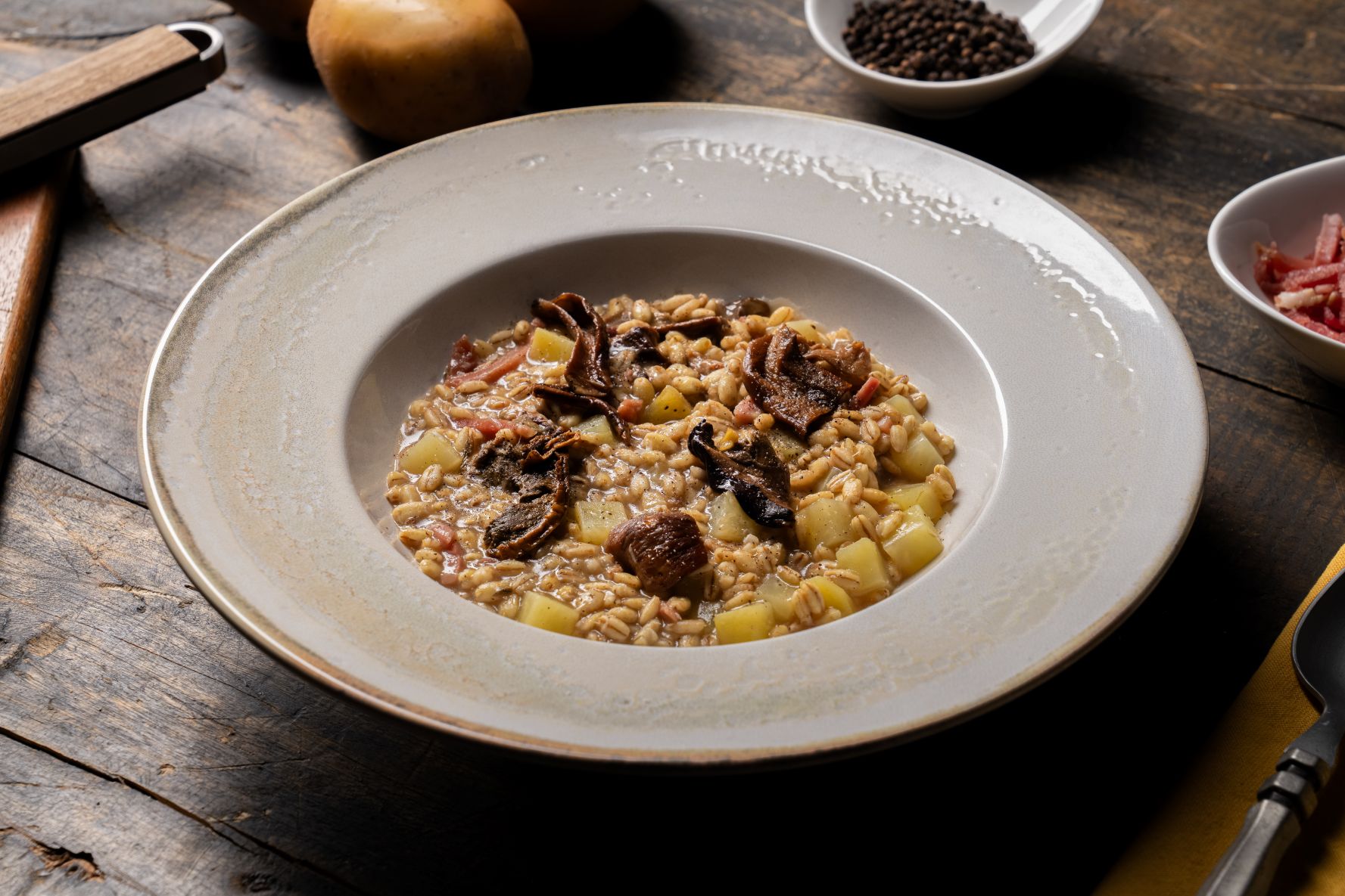 Orzotto with speck, mushrooms and potatoes